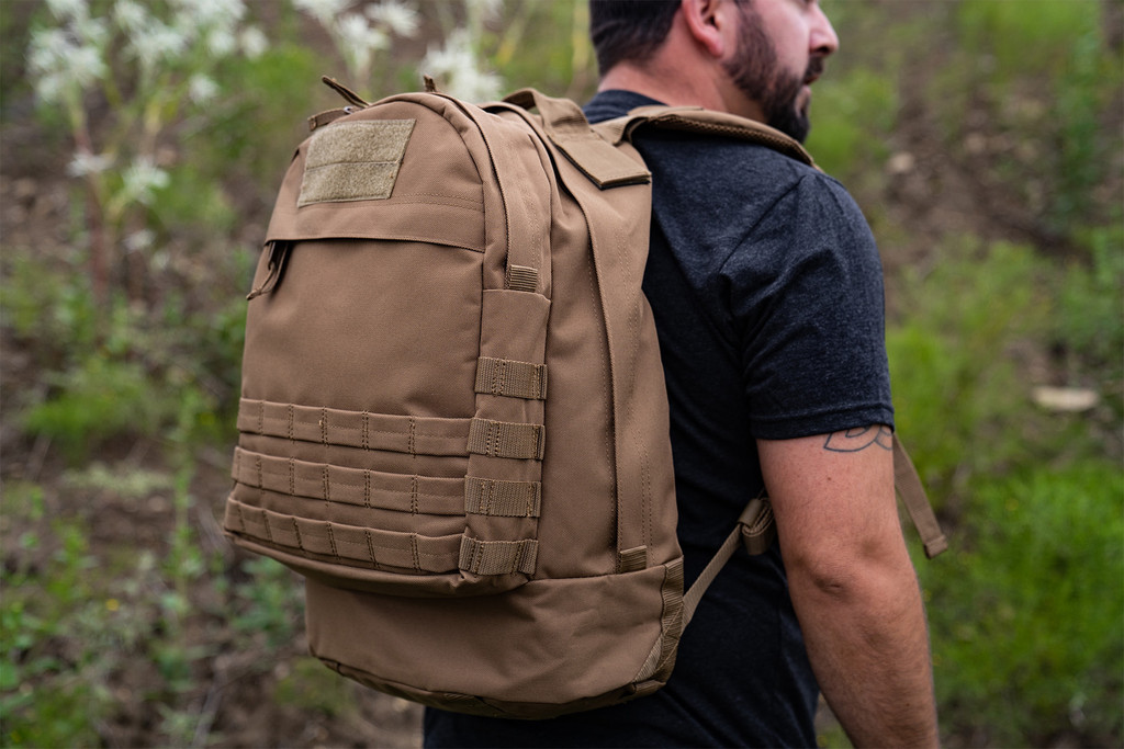 Coyote Brown Pecos Backpack worn outdoors.