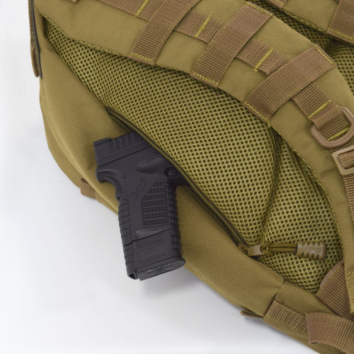 Two hidden backside pockets with zippers on both sides can be used as secure concealed carry compartments and for everyday carry essentials like wallet, keys, and knives. Close up of pocket on Pecos Tactical Backpack in Coyote Brown with handgun inside.