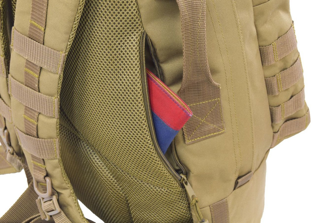 Two hidden backside pockets with zippers on both sides can be used as secure concealed carry compartments and for everyday carry essentials like wallet, keys, and knives.  Close up of pocket on Pecos Tactical Backpack in coyote brown with a pocket book inside.