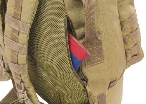 Two hidden backside pockets with zippers on both sides can be used as secure concealed carry compartments and for everyday carry essentials like wallet, keys, and knives.  Close up of pocket on Pecos Tactical Backpack in coyote brown with a pocket book inside.