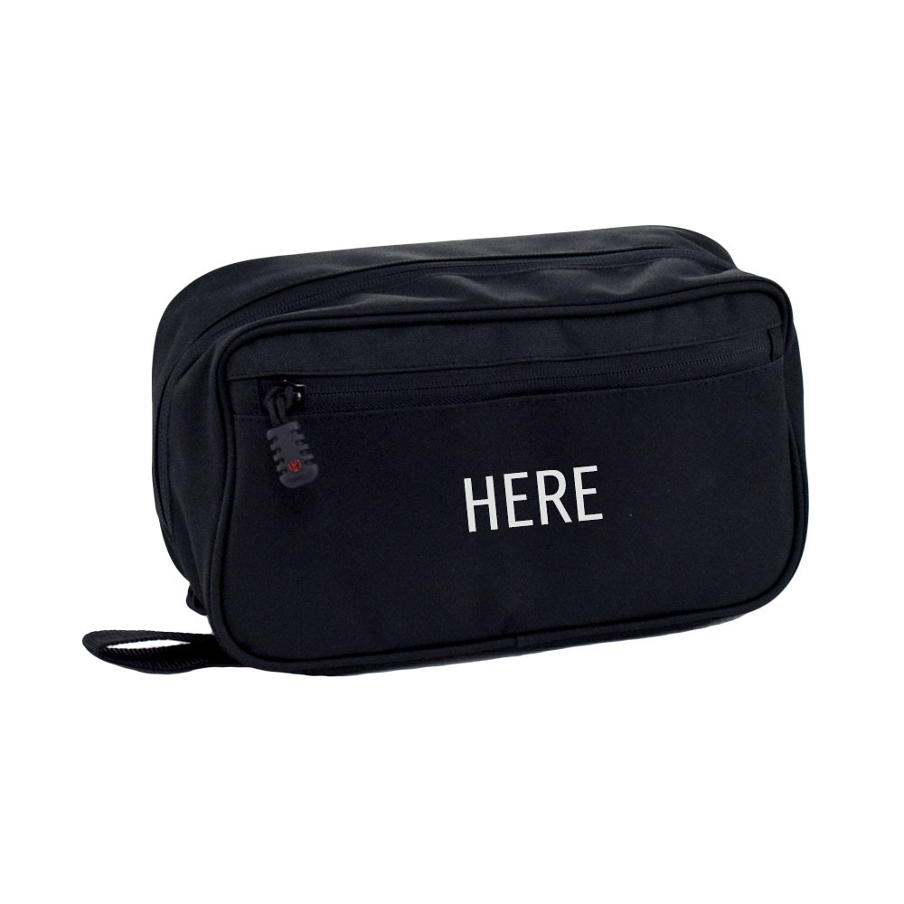 Concho Hanging Toiletry Bag in black shown closed with zippered pocket on front and monogram placement on center of bag.