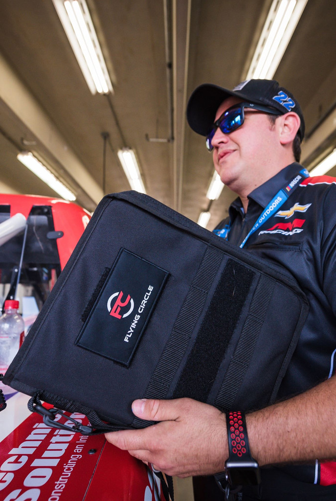 Black Secret Square Tactical Padfolio used in a racing shop.