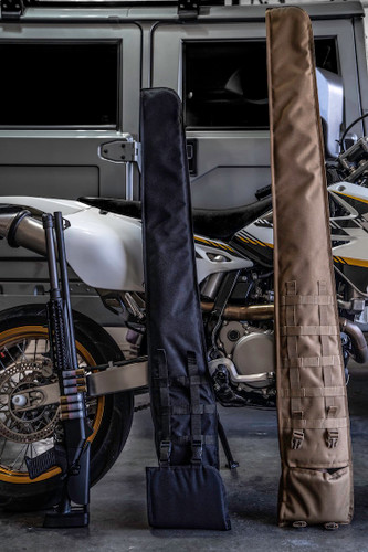 Black and coyote brown Shotgun Scabbards leaning up against a motorcycle.